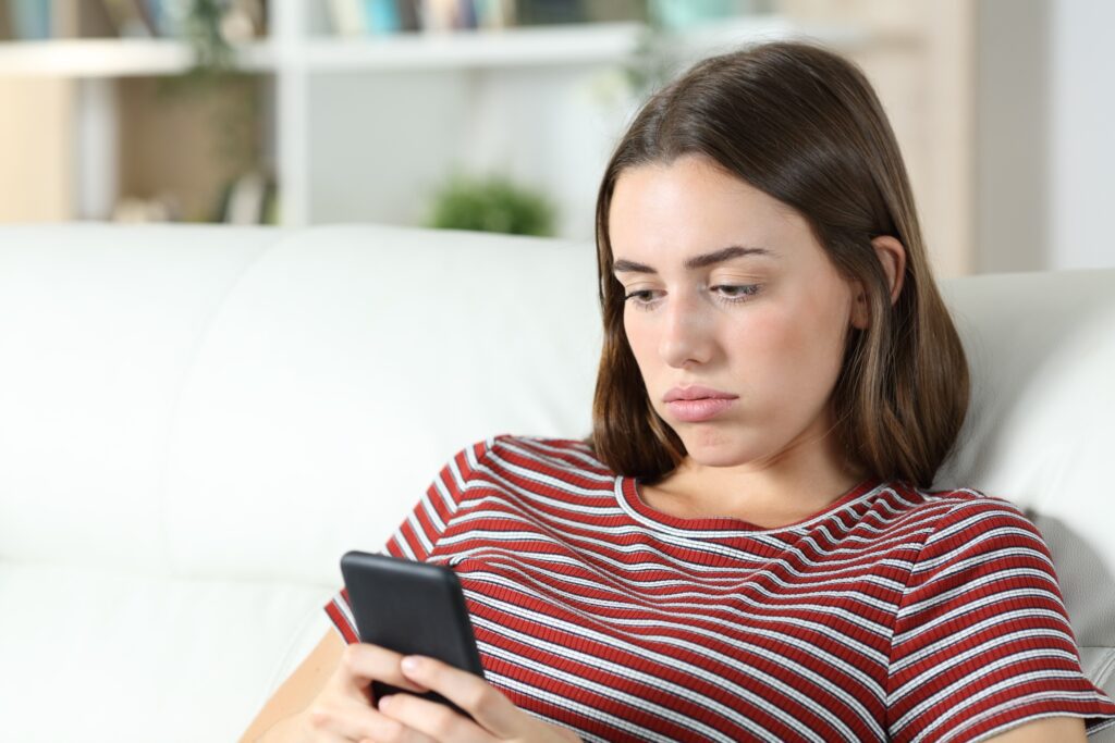 Image of teen looking at her cell phone