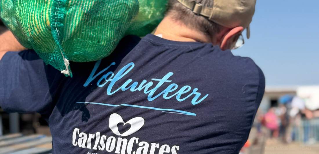 voluntario cargando un saco de repollo, voluntarios de Carlson Cares distribuyen alimentos en Killeen