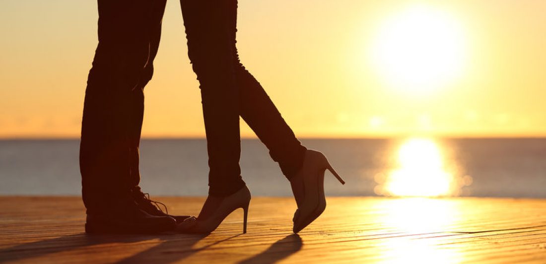 Couple legs falling in love hugging at sunset