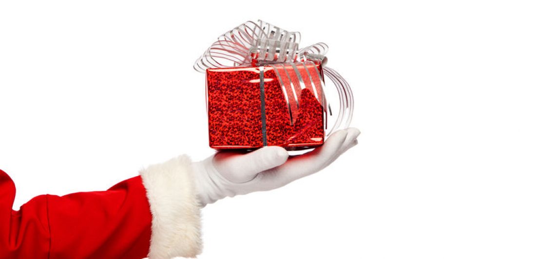 Santa claus giving  christmas present box on a white background, isolated.