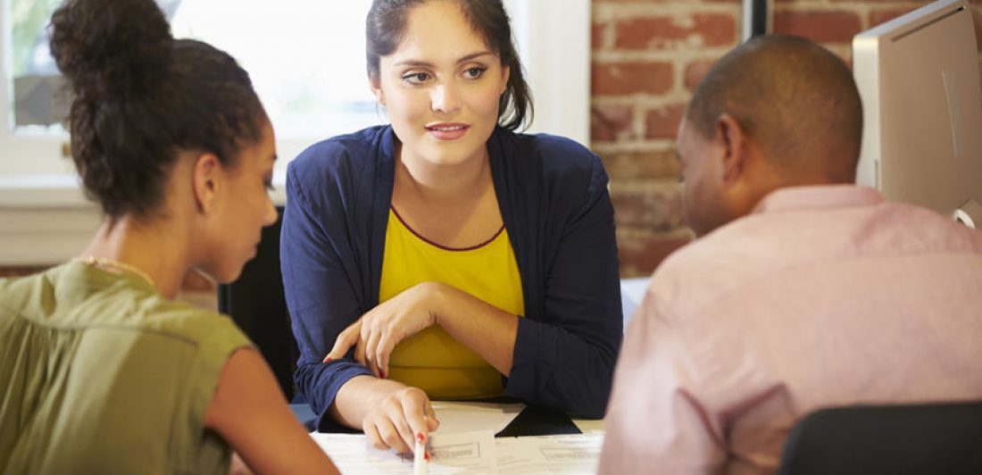 Couple Meeting With Financial Advisor In Office arbitraje de hogares de ancianos